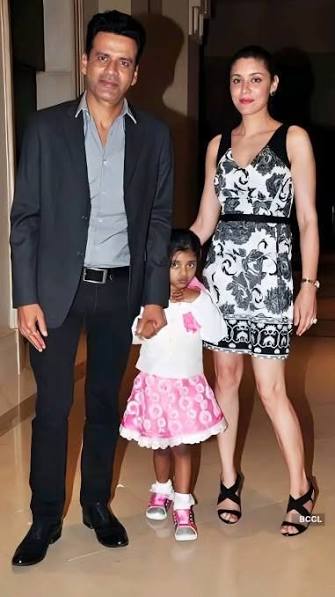 Ava Nayla as a young child holding her mother’s hand beside her father Manoj Bajpayee at an evening event.